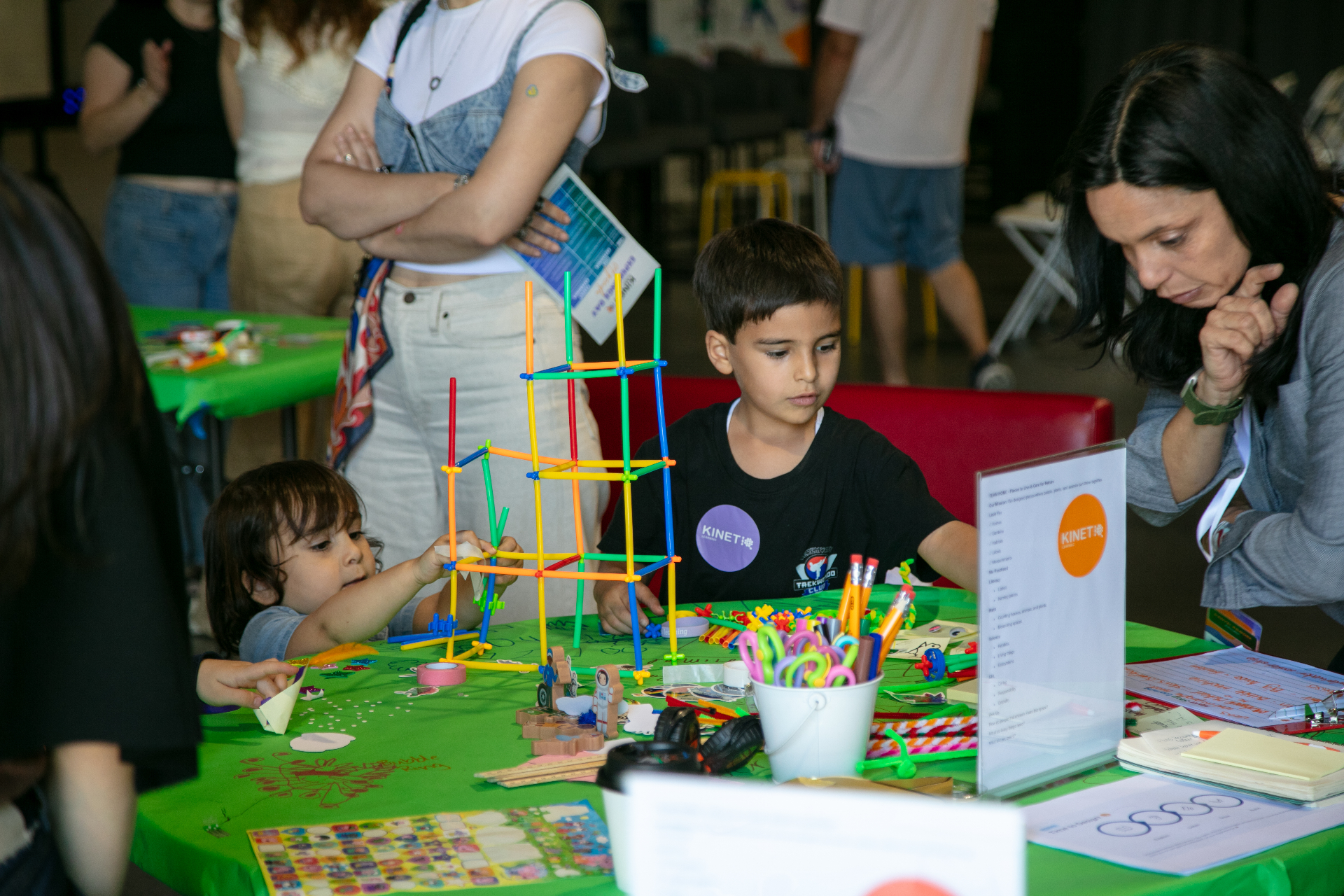 Children at a hands-on KinetIQ activity table