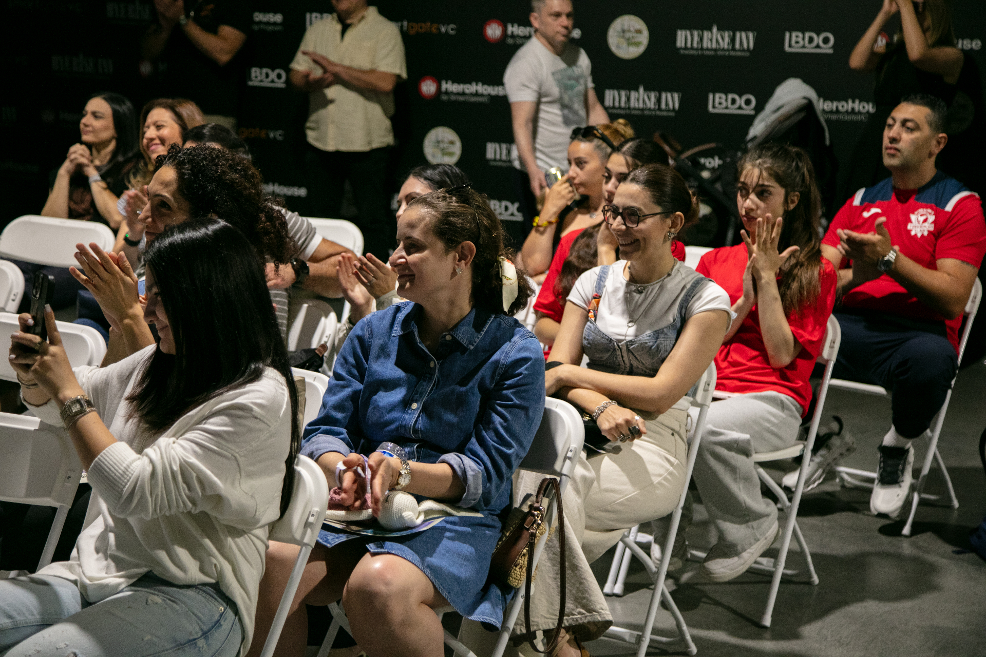 Audience clapping at a KinetIQ event